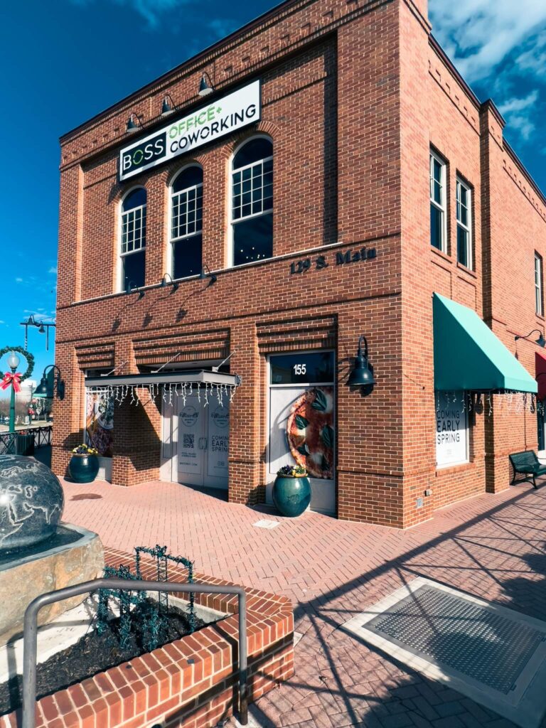 A brick building with a sign reading "BOSS Office + Coworking"
