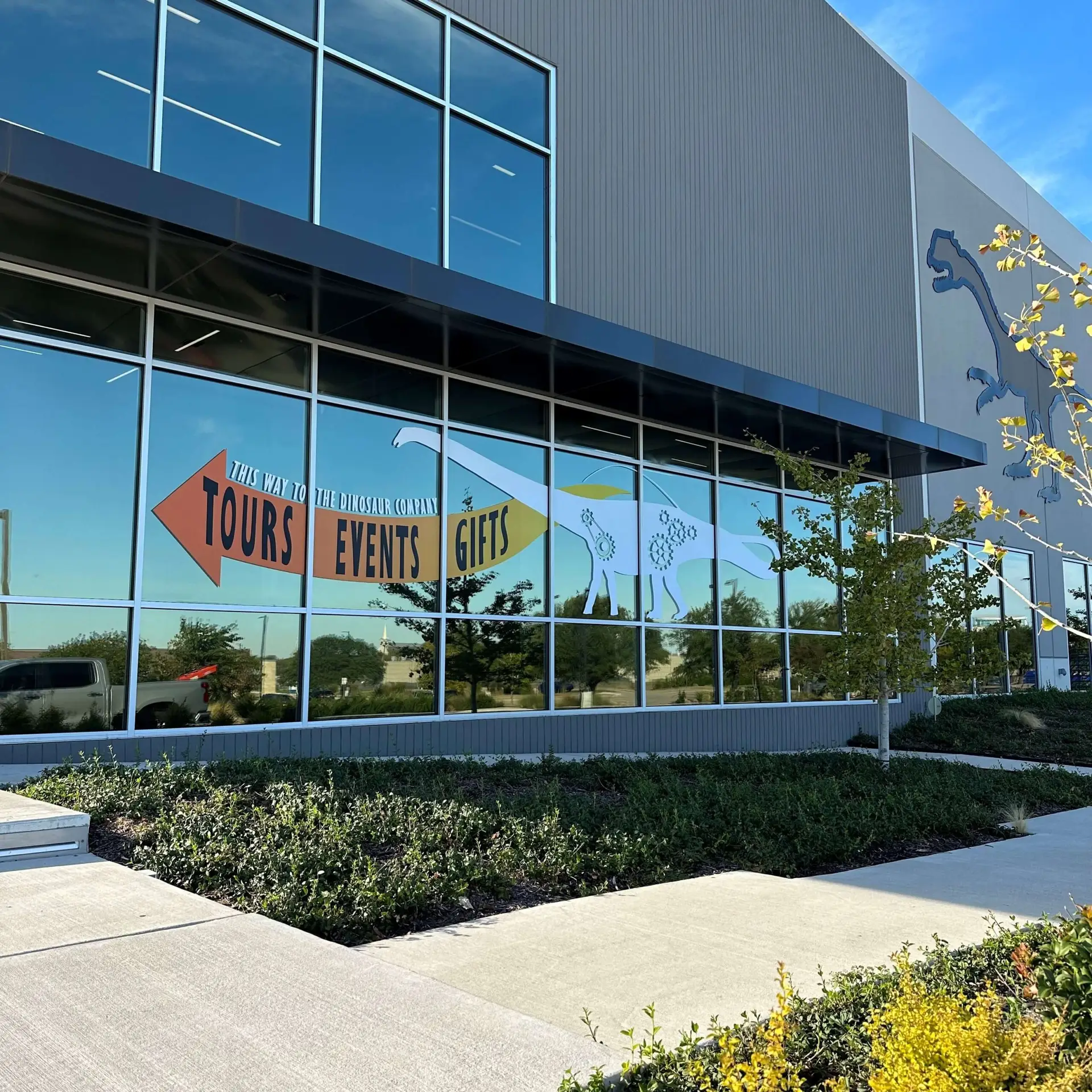 A building with glass wrap-around windows that have decal stickers on the side