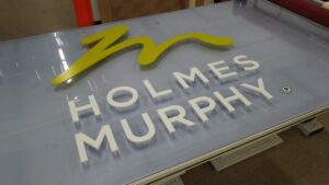 A glass sign reading "Holmes Murphy"