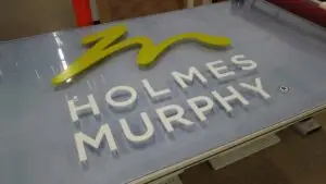 A glass sign reading "Holmes Murphy"