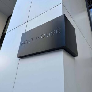 A wrap-around sign on a column that reads 'MINT HOUSE'