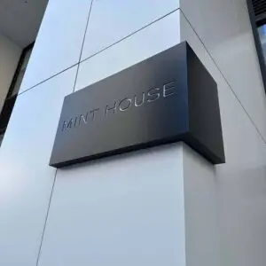 A wrap-around sign on a column that reads 'MINT HOUSE'