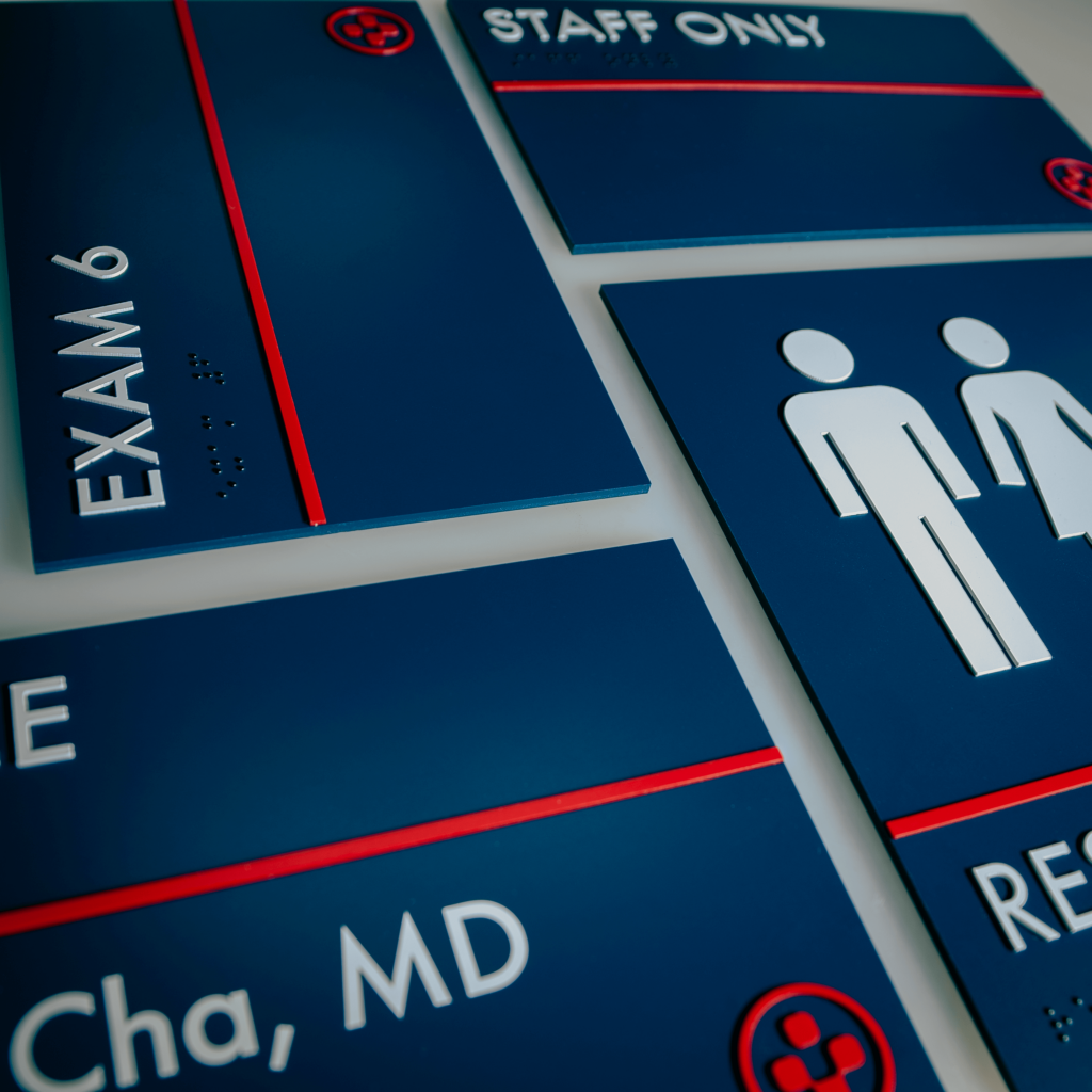 A collection of room signage, including 'staff only', restroom signs and exam room signage
