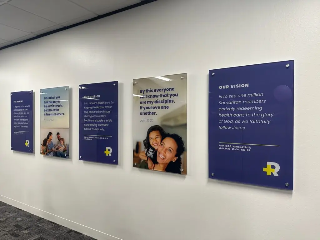 Acrylic mission and values displays along a healthcare facility corridor